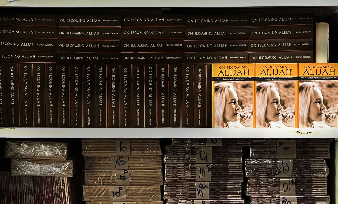 Bound volumes and stacks of published books stored on shelving.